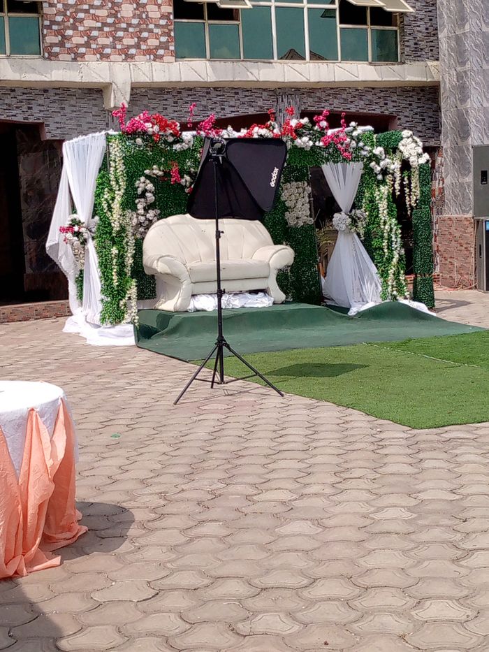 Beautiful floral wedding arch and setup outdoors in Unity, Saskatchewan.
